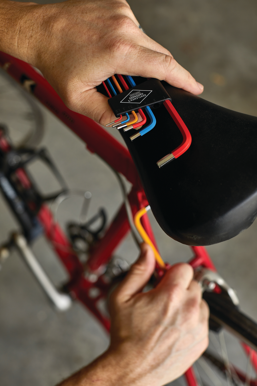 Hex keys in use on a bicycle seat. 