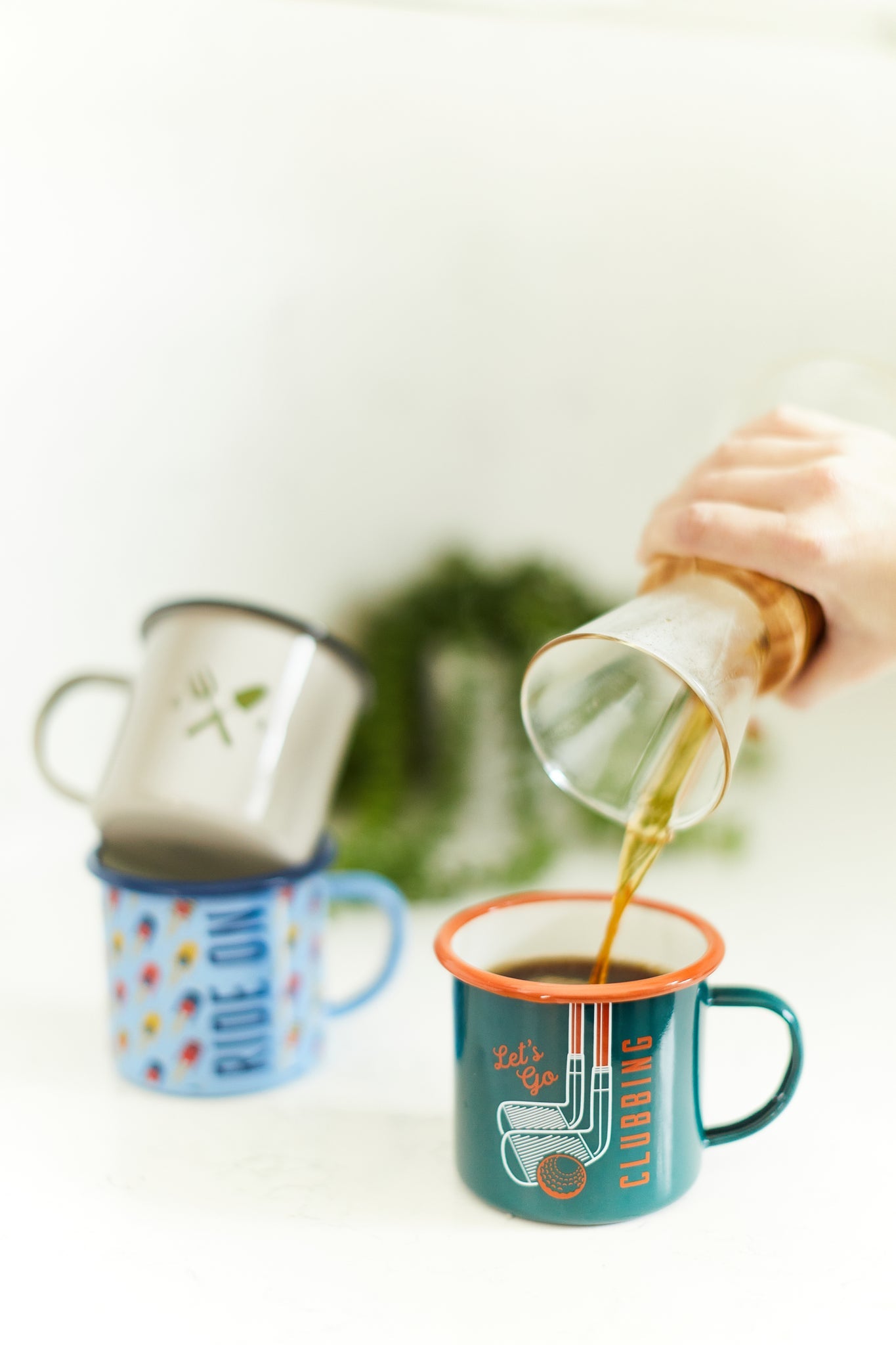 Photo of three enamel mugs.