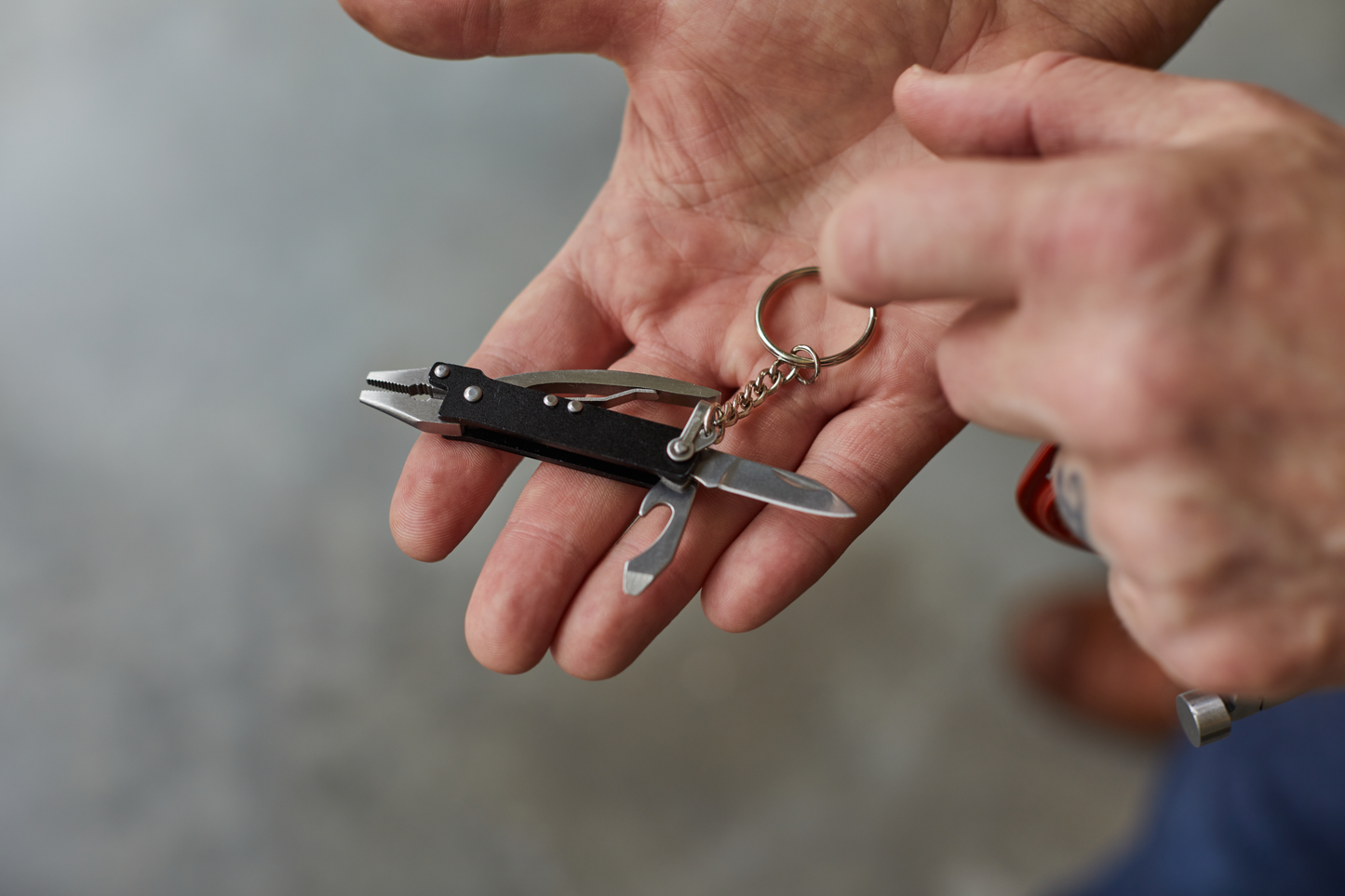 Mini pliers in an open hand.