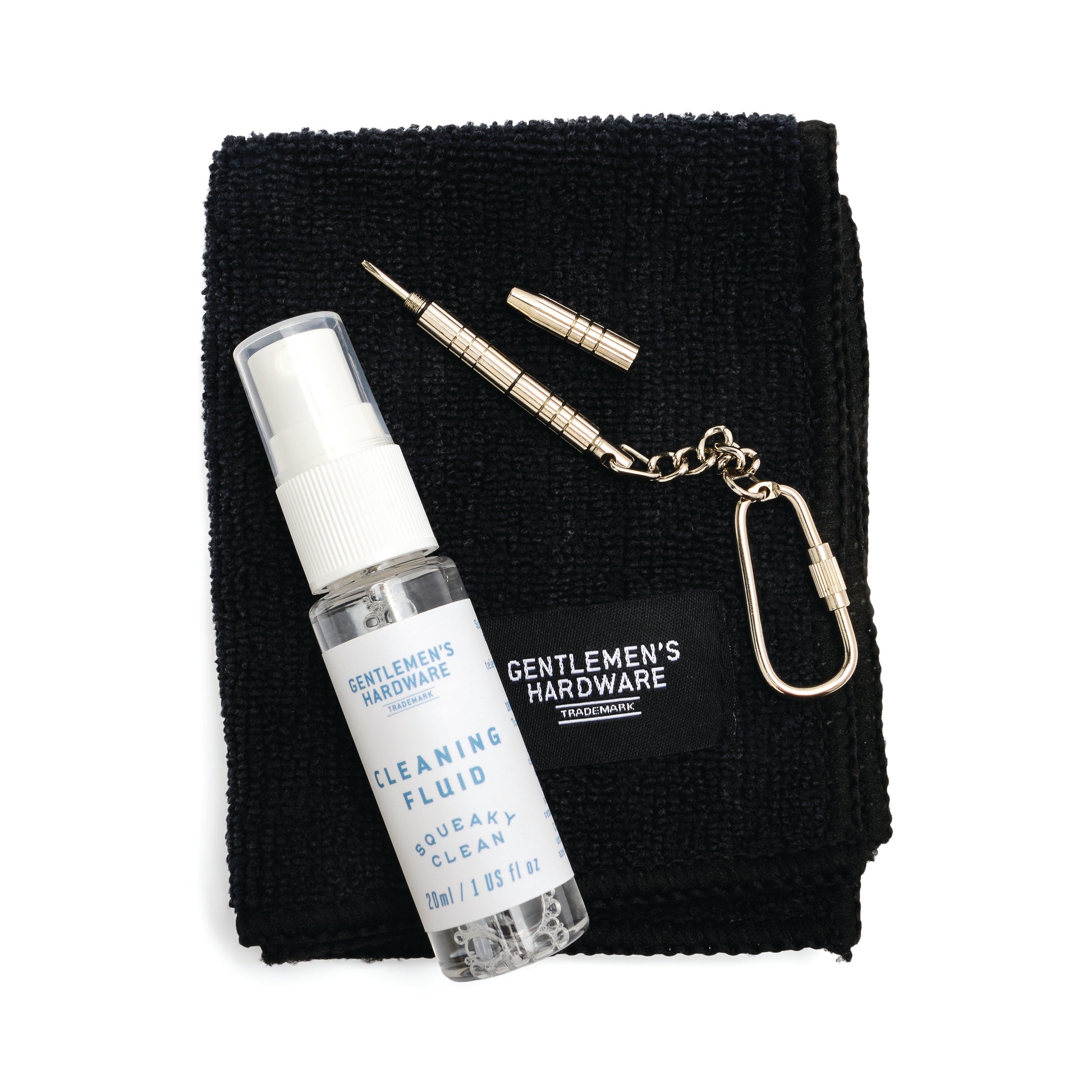 The Squeaky Clean Clean & Repair Kit includes a black cloth, cleaning fluid spray, mini screwdriver, and keychain—all labeled Gentlemens Hardware.