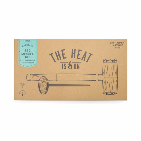 A brown box labeled “THE HEAT IS ON” contains the BBQ Lovers Kit: Meat Tenderizer & Thermometer, with line drawings illustrating both tools.