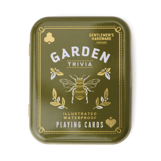 A green metal tin labeled Gardeners Tips Waterproof Playing Cards, featuring garden-themed illustrations, gold accents, and a bee on the lid—crafted from waterproof material for durability.