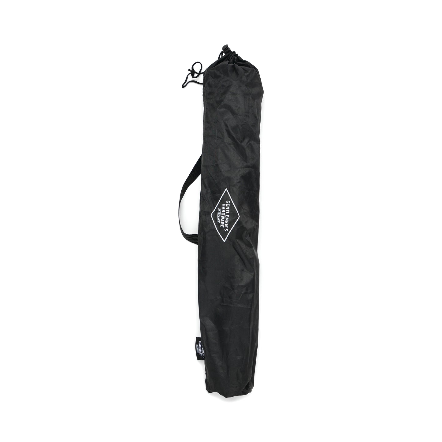 A black, cylindrical carrying bag with a handle and a diamond-shaped logo patch on the front—ideal for storing your Tripod Camp Stool—photographed against a white background.