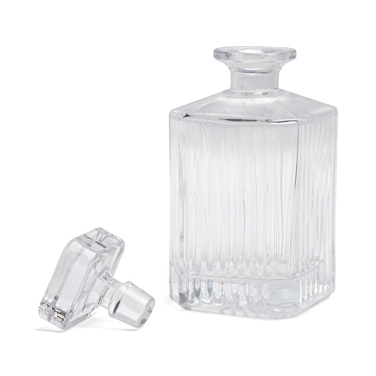 The Whisky Decanter features clear glass with geometric vertical ridges and a matching stopper—an elegant, vintage-style addition to your at-home bar collection.
