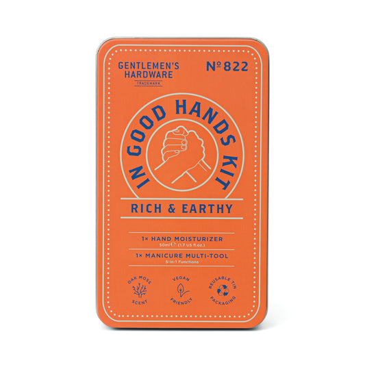 In Good Hands Kit: rectangular orange tin with hand moisturizer and manicure multi-tool. Features vegan, recyclable, and cruelty-free icons.