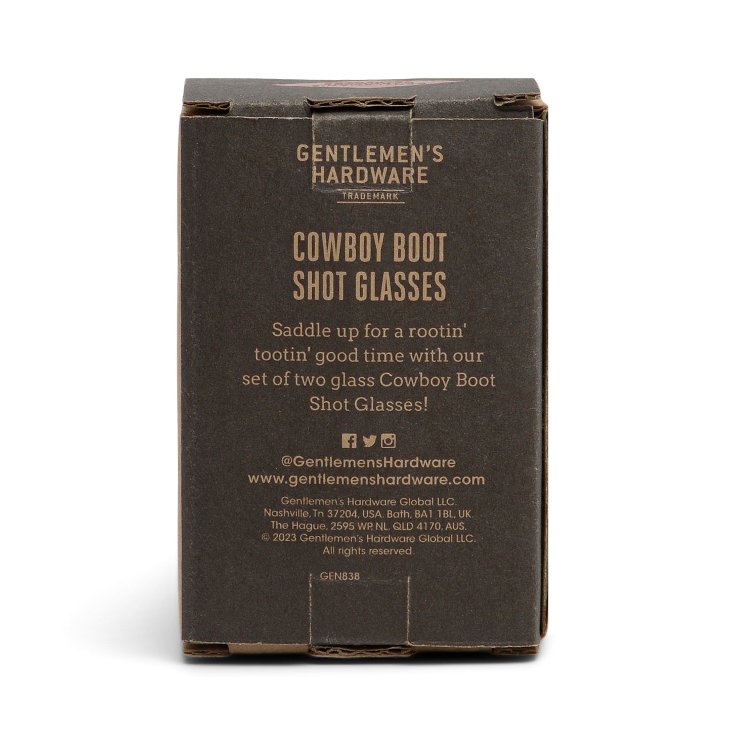 A brown box labeled Set of 2 Cowboy Boot Shot Glasses, featuring product details and company info on the front—perfect for adding to your at-home bar kit.