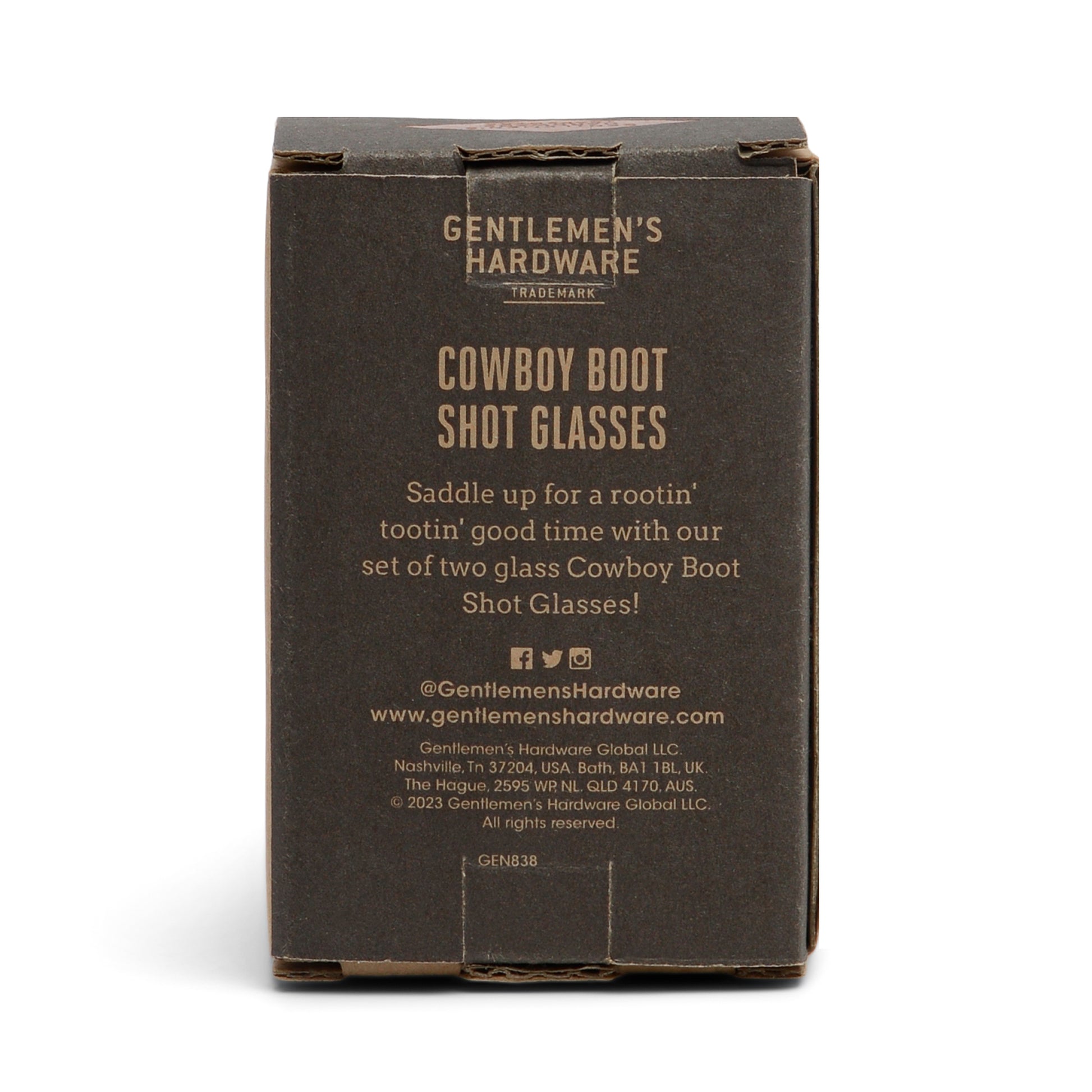 A brown box labeled Set of 2 Cowboy Boot Shot Glasses, featuring product details and company info on the front—perfect for adding to your at-home bar kit.
