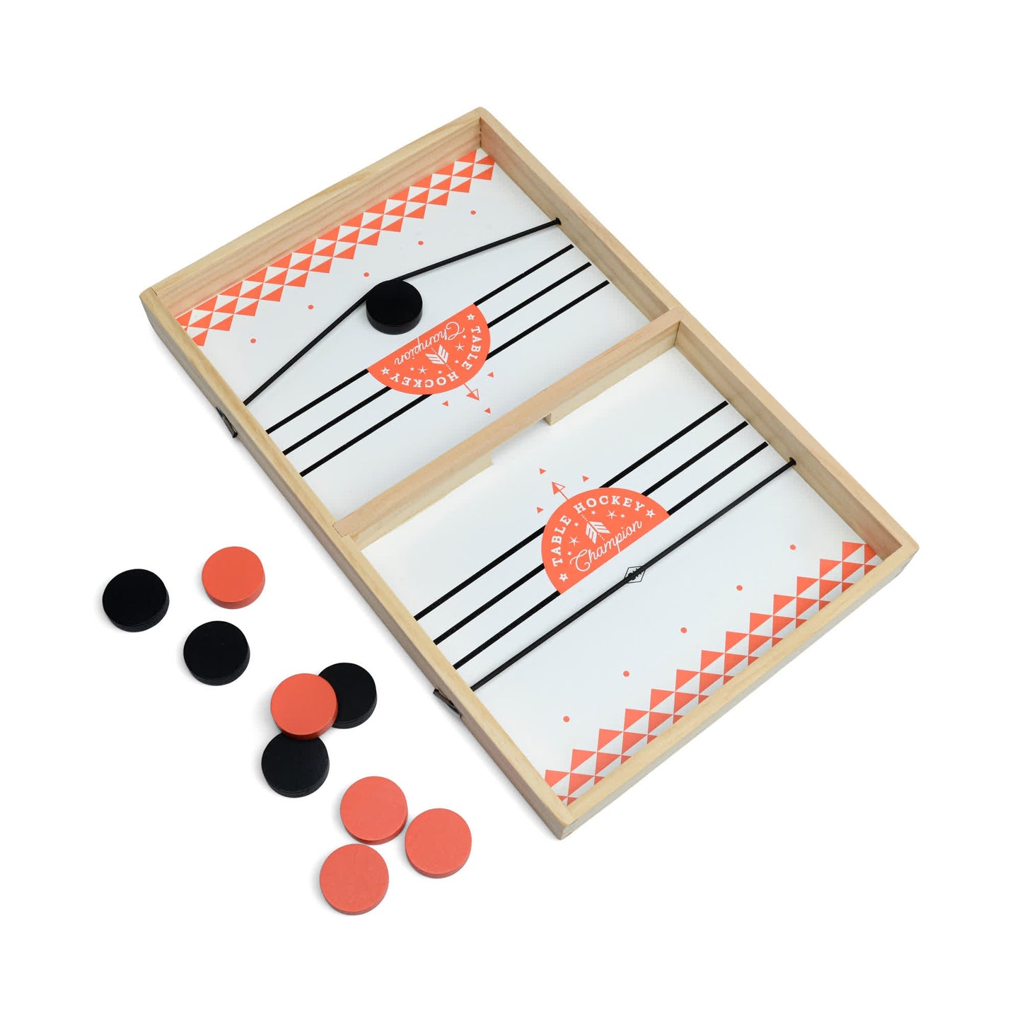 Table Hockey is an exciting tabletop game featuring a wooden playing board with a central divider, an elastic launcher, and black and orange discs scattered across the surface.