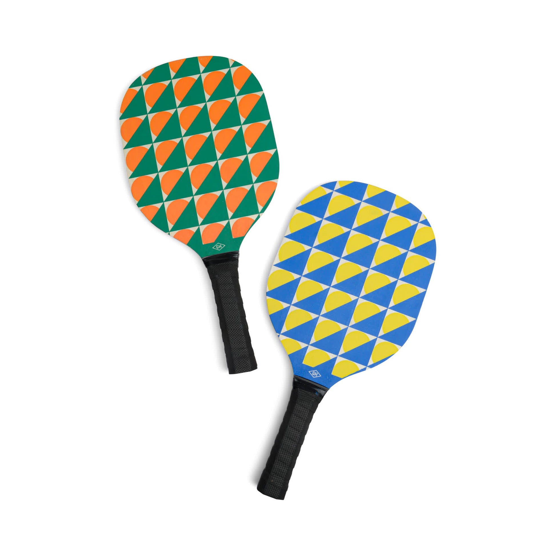 The Pickle Ball Set features two paddles—one with green and orange, the other with blue and yellow geometric patterns—each designed for exciting matches and equipped with a comfortable black handle.