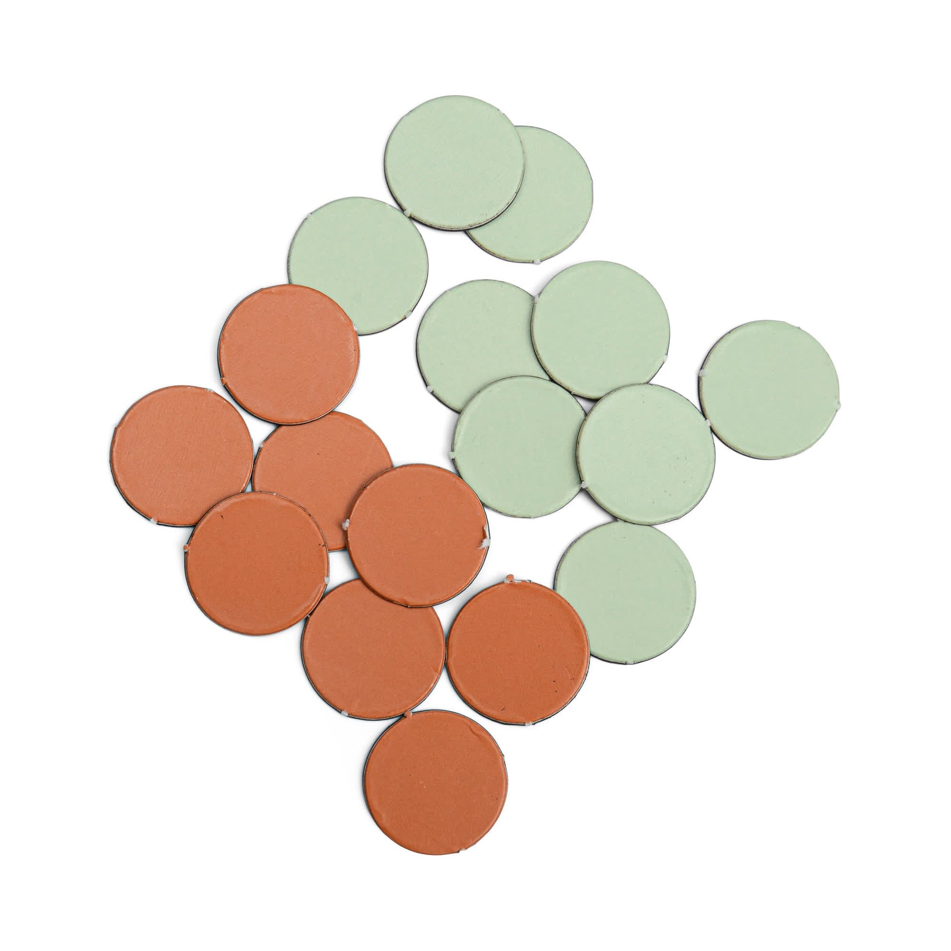 A set of round, flat tokens from the Travel Backgammon game, featuring eleven green and eight brown pieces, neatly arranged on a white background—ideal for play on a magnetic surface.