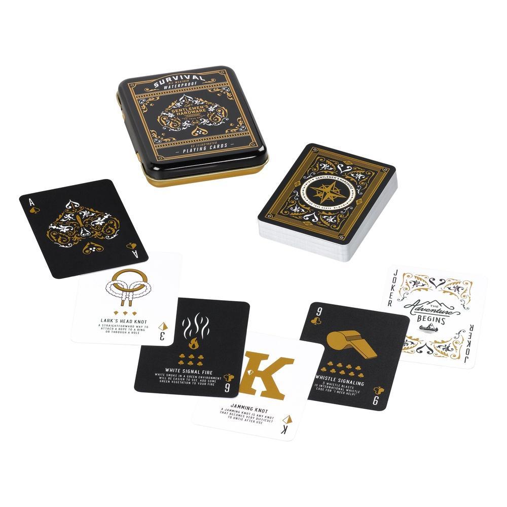 The Survival Playing Cards in Tin feature a black and gold design with survival tips on each card, shown face up beside the matching decorative tin. These waterproof cards are ideal for any adventure.