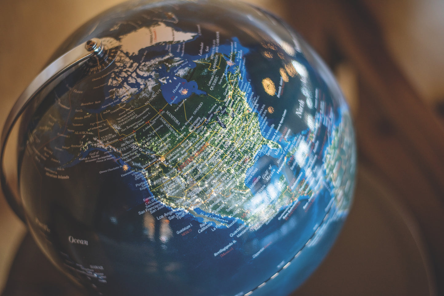 The Globe Light 12 inch City Lights features North America—Canada, the US, and Mexico—with clear place names and borders, illuminated by a gentle glow that mimics nighttime city lights for enhanced detail and ambiance.