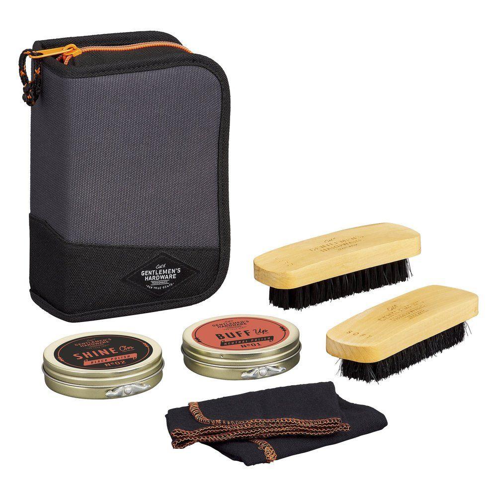 The Shoe Shine Kit is a compact, travel-friendly set with a zippered black pouch, two wooden brushes, two shoe polish tins, and both a black and brown cloth for easy care on the go.