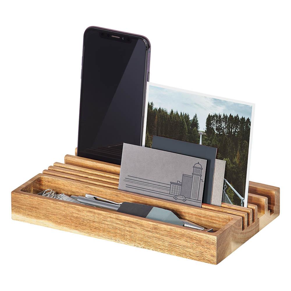 The Wooden Desk Organizer & Phone Stand holds your smartphone with its built-in stand, plus pens, business cards, and a photo.