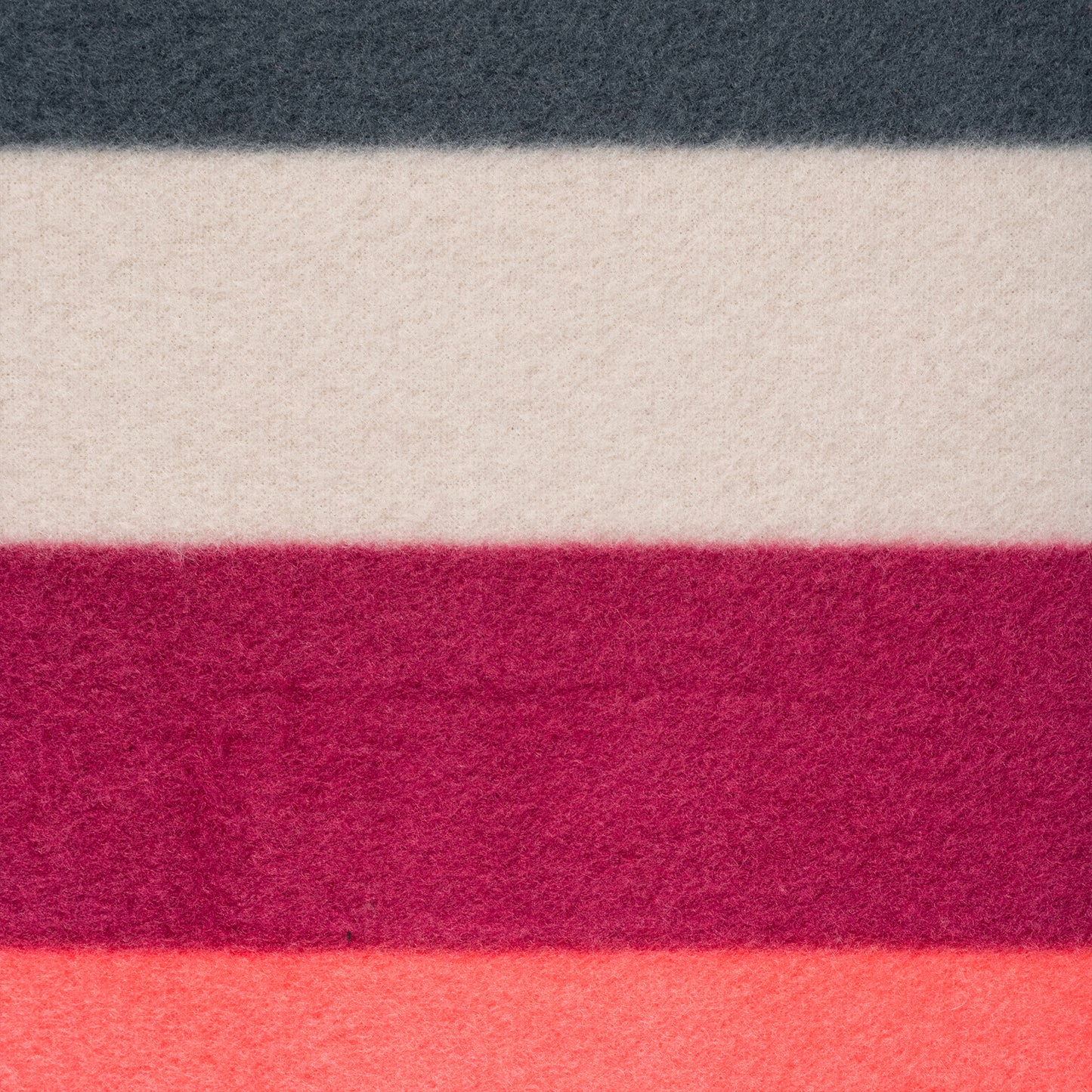 The Camping Blanket is a lightweight woolen fabric featuring horizontal stripes in dark gray, off-white, maroon, deep red, and coral pink—ideal for outdoor adventures.