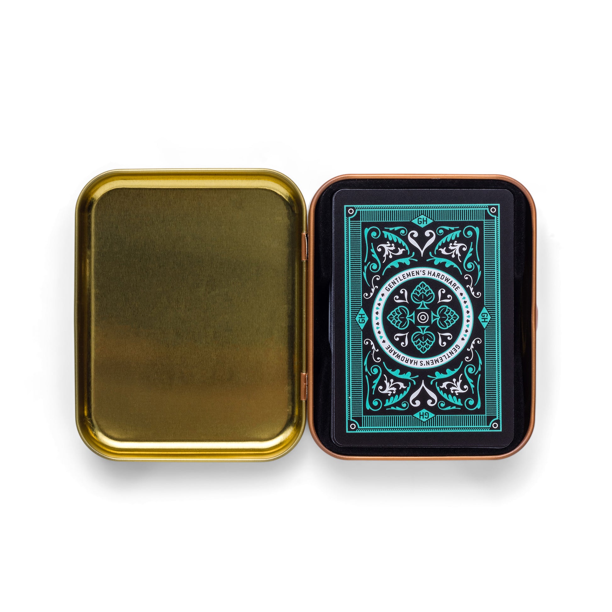 An open gold metal tin travel case reveals the Cocktail Playing Cards, featuring an ornate blue-green back design, neatly placed in the right compartment.