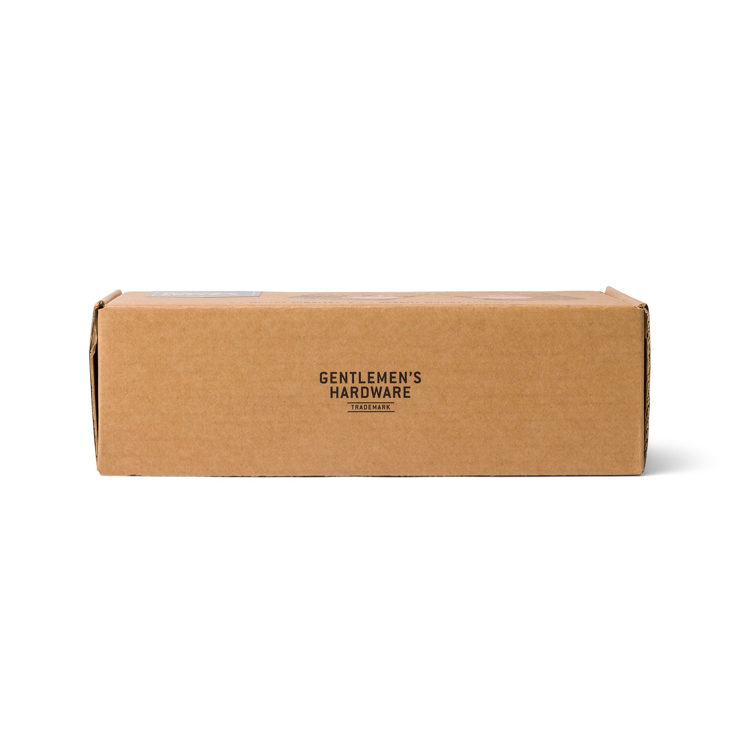 A rectangular brown cardboard box with Gentlemens Hardware printed in black on the front, ideal for housing the Whiskey Tumbler Glasses & Ice Stones Set.