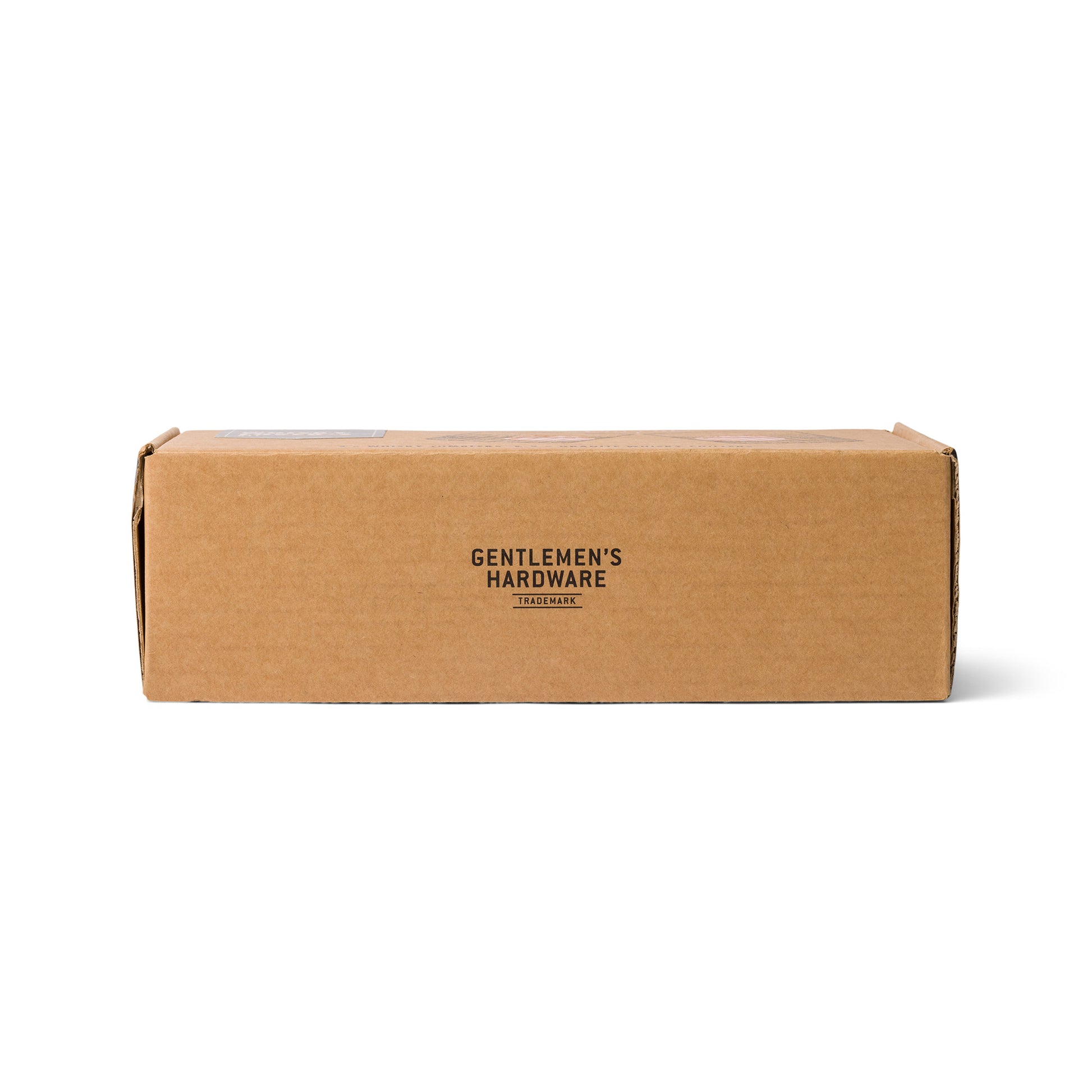 A rectangular brown cardboard box with Gentlemens Hardware printed in black on the front, ideal for housing the Whiskey Tumbler Glasses & Ice Stones Set.