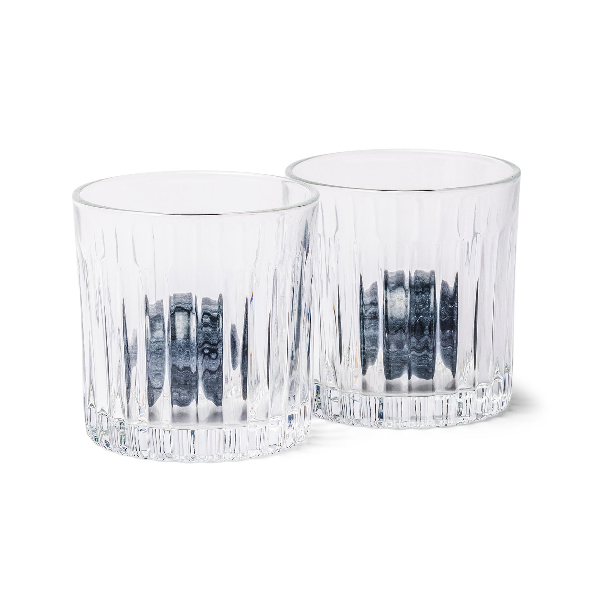 Two clear, textured whiskey tumblers from the Whiskey Tumbler Glasses & Ice Stones Set sit side by side on a white background—an ideal addition to any stylish home bar gift set.