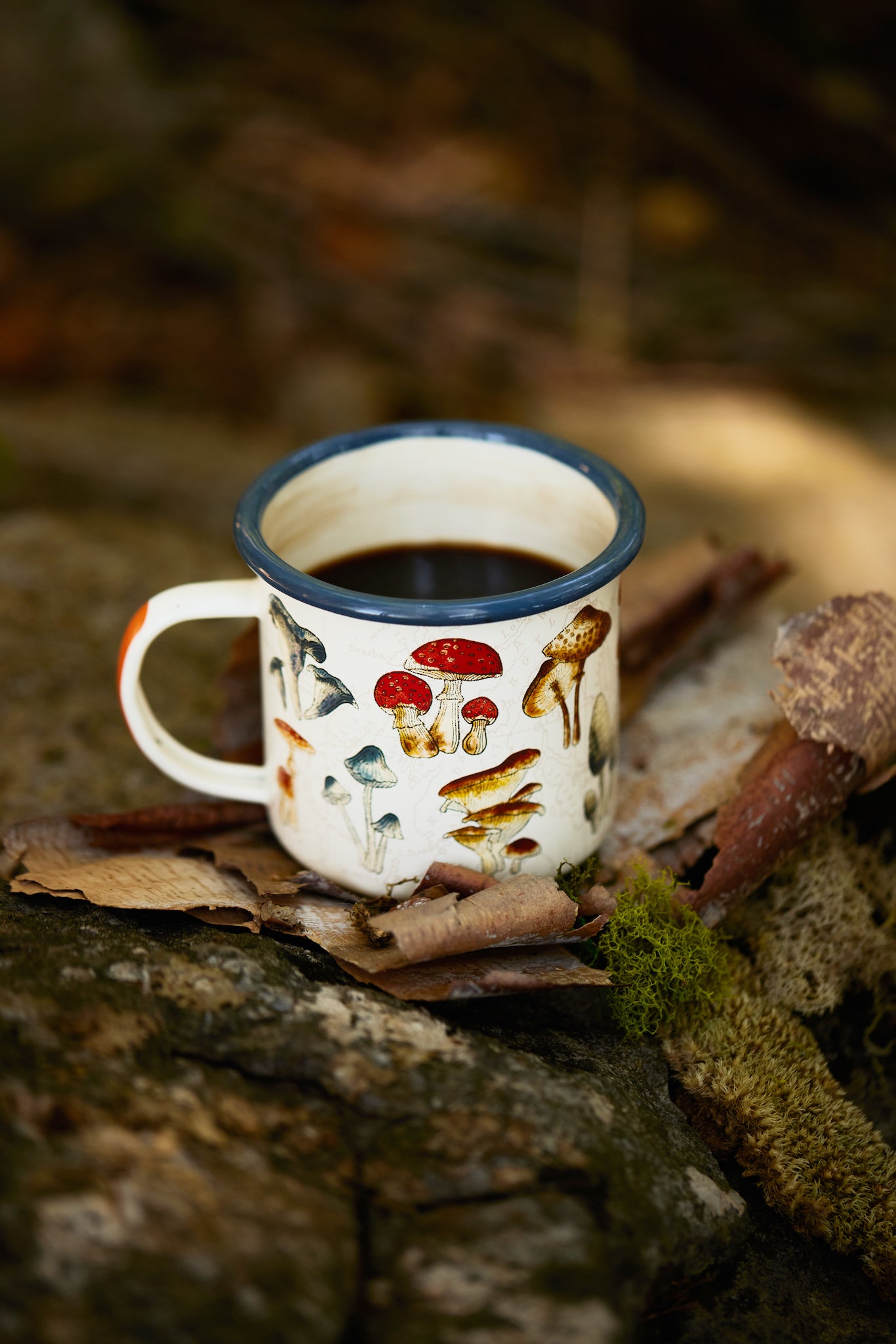Enamel Mug - Mushroom 17 fl oz filled with coffee in wilderness on bark shards