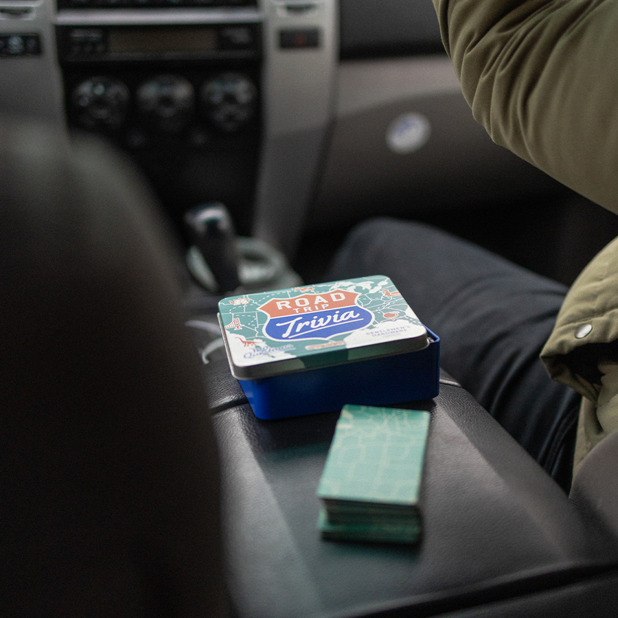road trip trivia - deck of cards and container sitting on middle console of car