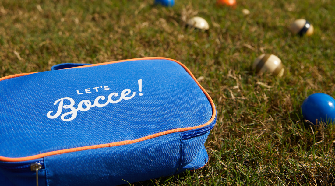 Bocce Balls in blue and stripes on grass lawn