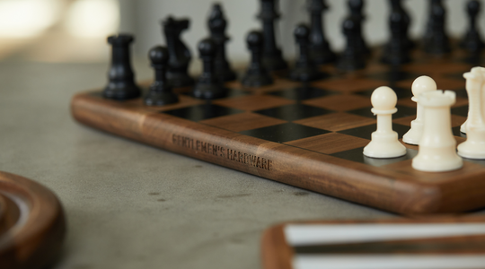 Wooden chess set with white and black pieces with gentlemen's hardware etched into the side