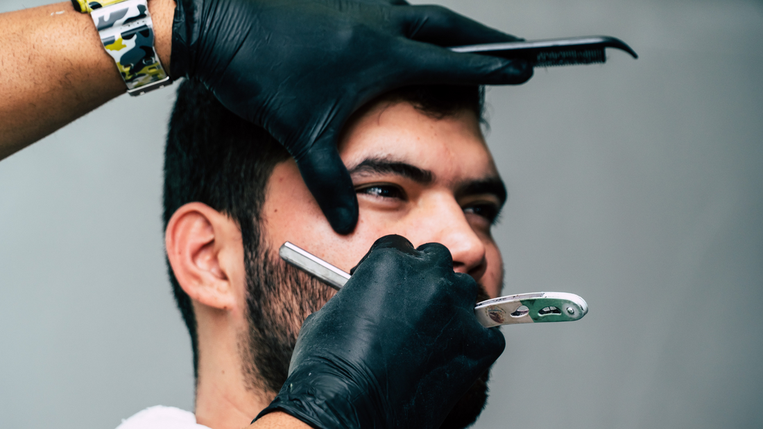 man getting straight razor shave