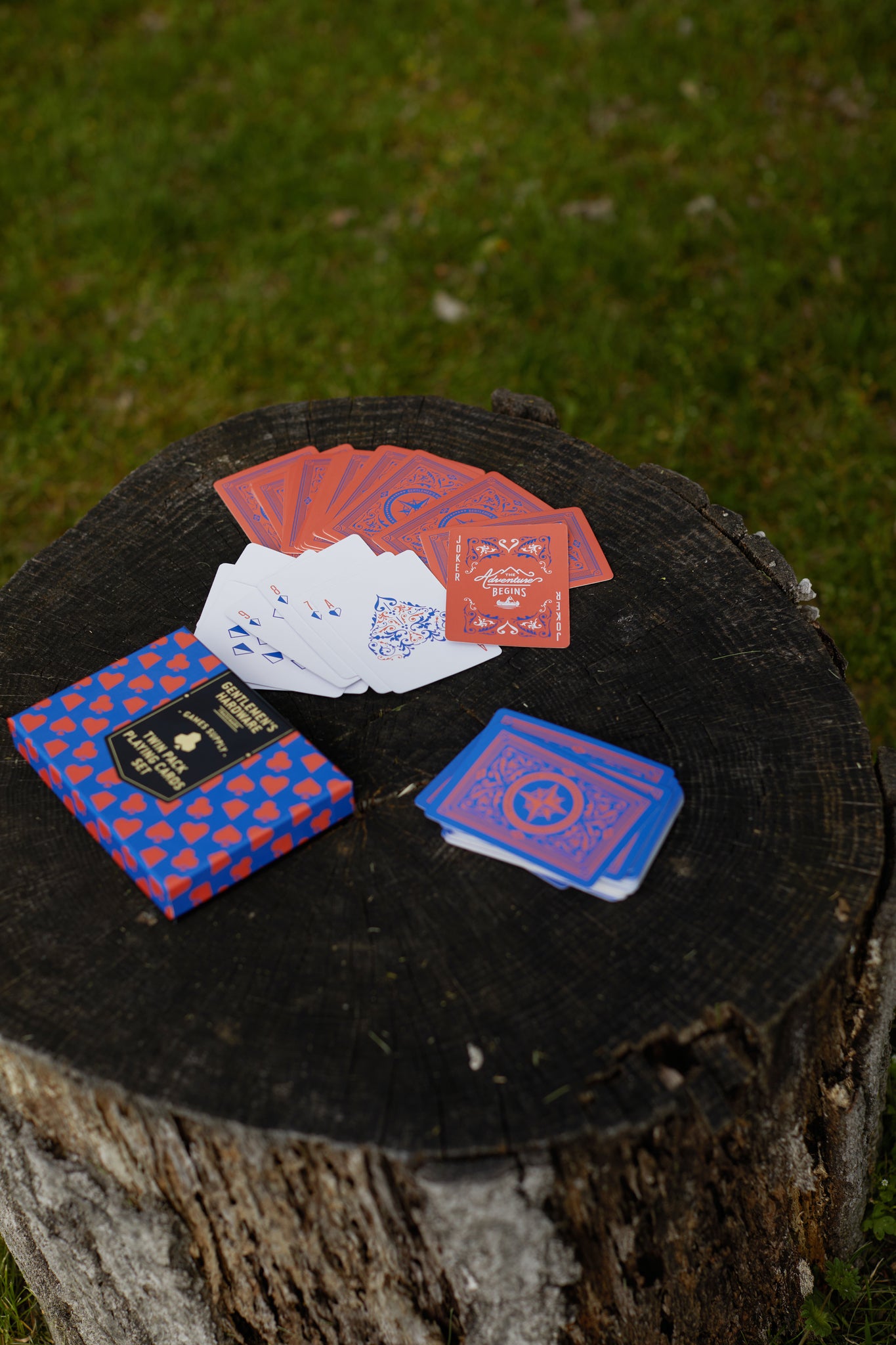 Gentlemen's Hardware Twin Pack Playing Cards fanned on a log with box