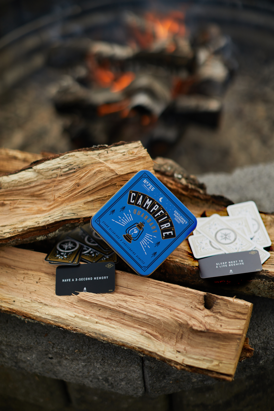 Campfire quandary cards on firewood. 