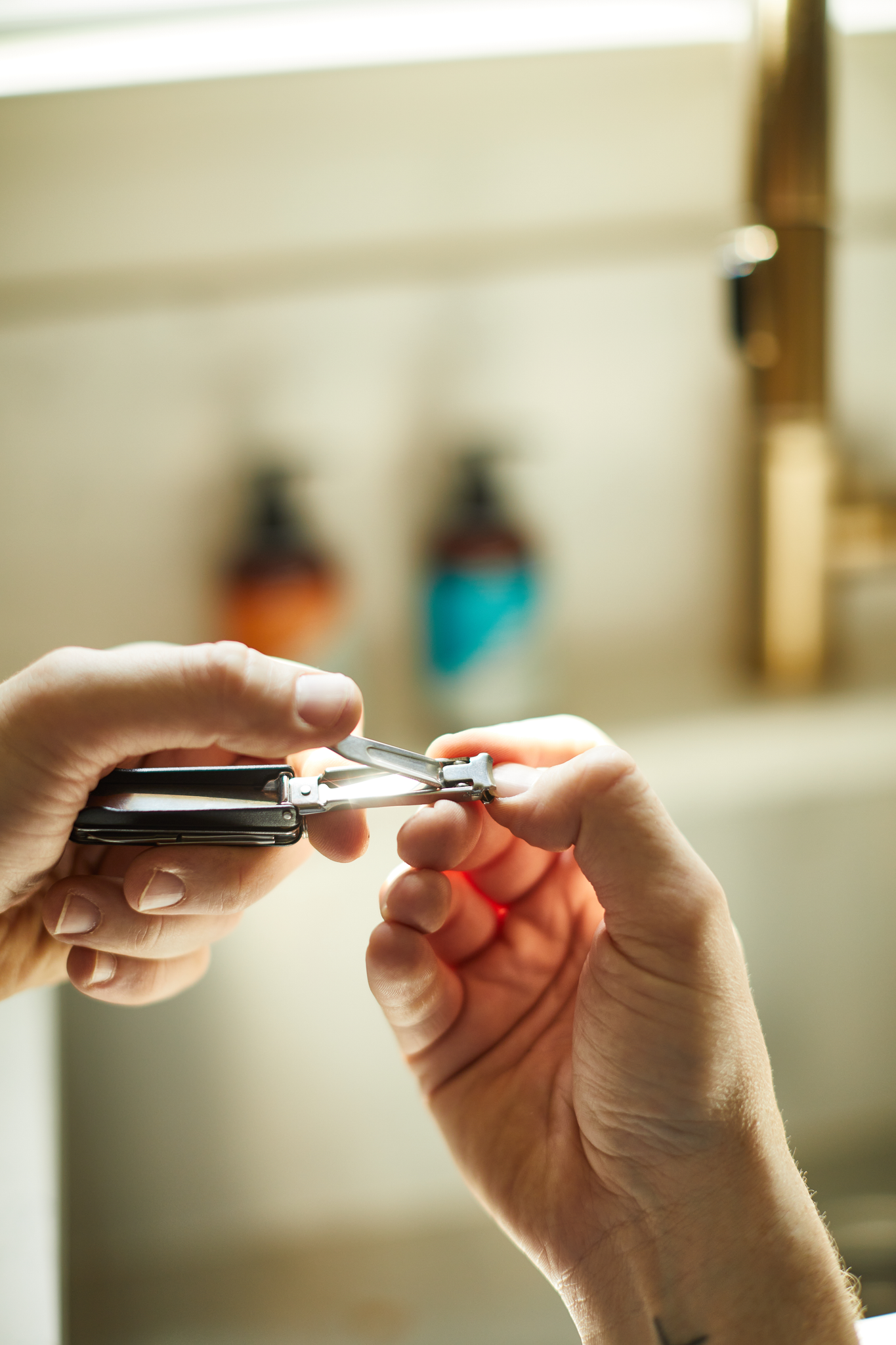 Manicure multi-tool nail clippers in use. 