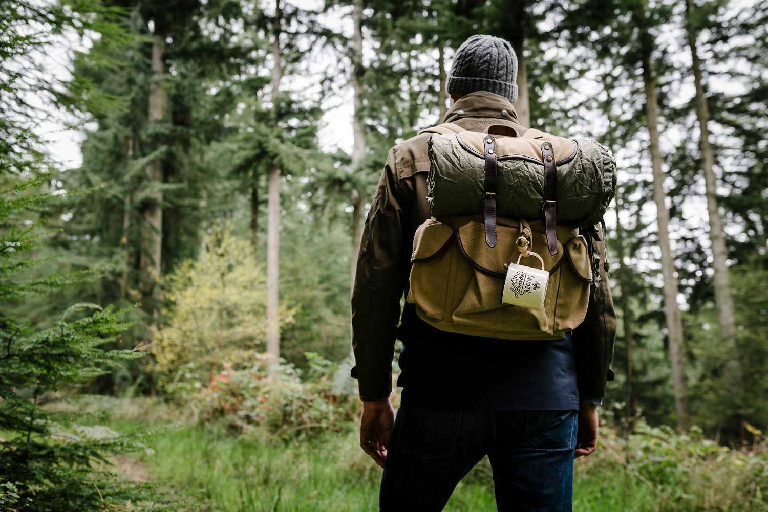 A person in the outdoors with his camping gear