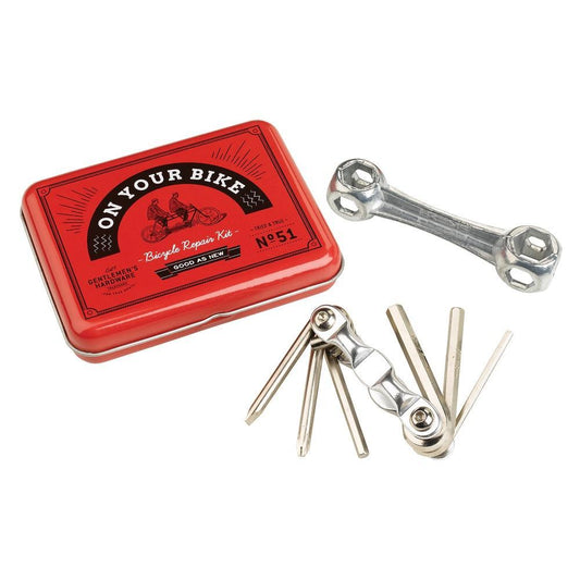 The Bicycle Repair Kit comes in a vintage-style tin labeled On Your Bike and includes a metal wrench, tire levers, and a multi-tool with screwdrivers and hex keys.