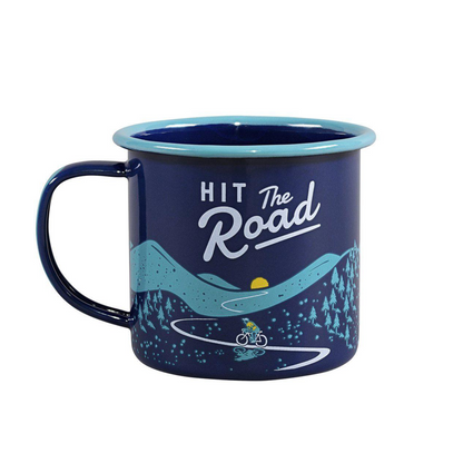The Enamel Mug - Hit the Road 11 fl oz features a blue design with Hit the Road and a biker riding through mountains and trees—ideal for camping or outdoor adventures.