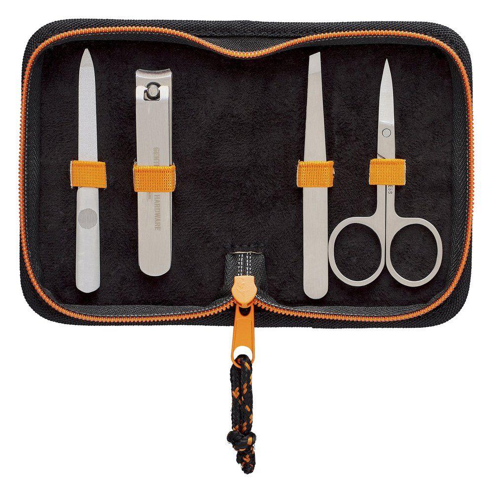 The Manicure Set comes in a black case with orange trim and includes stainless steel nail clippers, file, tweezers, and scissors—each held by orange elastic bands.