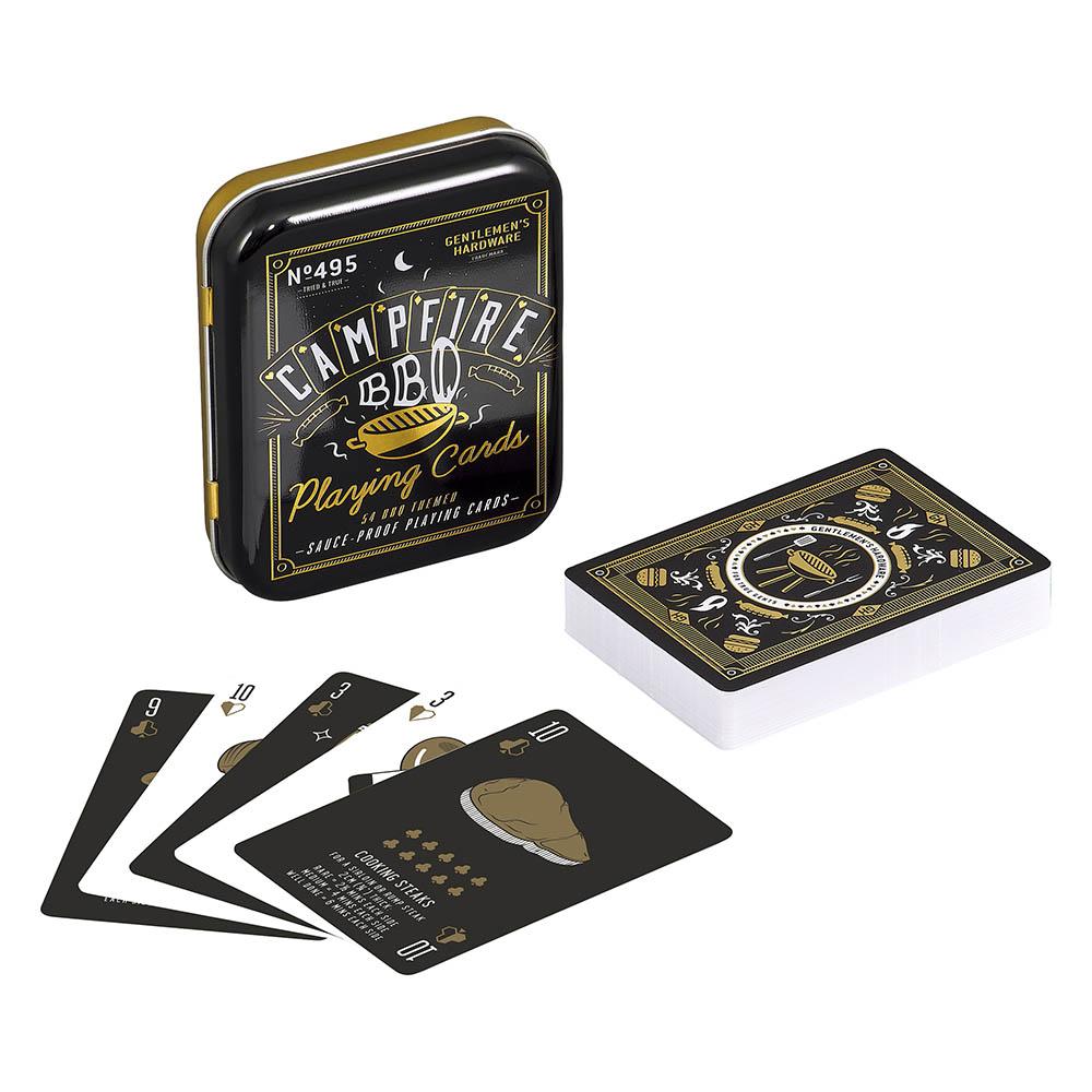 A tin labeled BBQ Playing Cards is shown with a deck of waterproof cards, some spread out to display BBQ-themed graphics and icons on a black background—ideal for outdoor activities.